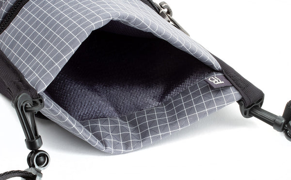 The main/phone pocket of the P.I.K.A. Pouch showing the one-way fabric.